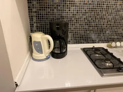 a kitchen counter with a coffee maker and a blender at Gold ROOM in Kraków