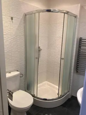 a bathroom with a shower with a toilet and a sink at Gold ROOM in Kraków