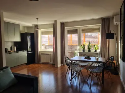 a kitchen and dining room with a table and chairs at Home4You in Kraków