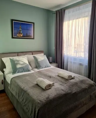 a bedroom with a bed with two pillows on it at Home4You in Kraków
