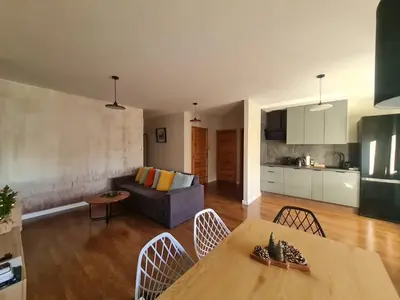 a living room with a table and a couch at Home4You in Kraków
