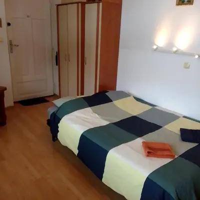 a hotel room with two beds and a door at Best location Private apartment in Kraków