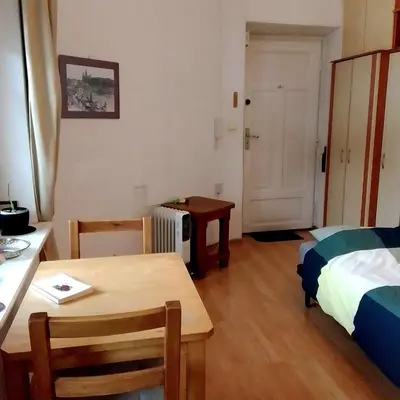 a small room with a table and a bed and a desk at Best location Private apartment in Kraków