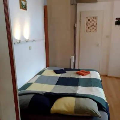 a bedroom with a bed with a striped blanket at Best location Private apartment in Kraków