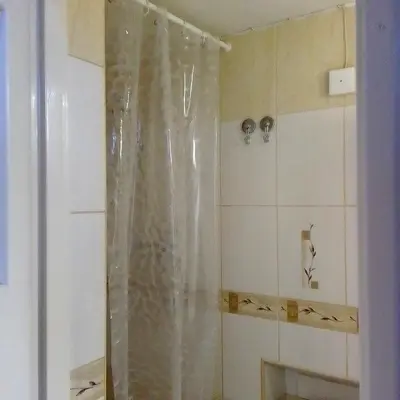 a shower with a clear shower curtain in a bathroom at Best location Private apartment in Kraków