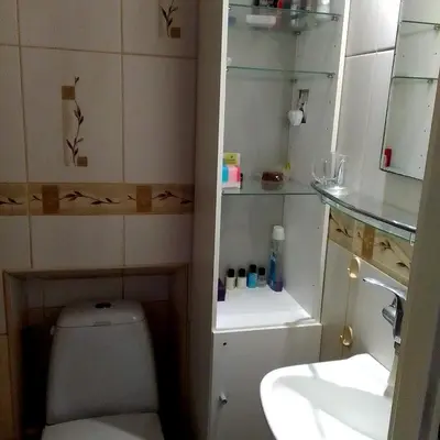 a small bathroom with a toilet and a sink at Best location Private apartment in Kraków