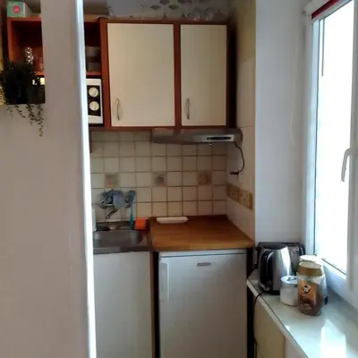 a small kitchen with a sink and a refrigerator at Best location Private apartment in Kraków