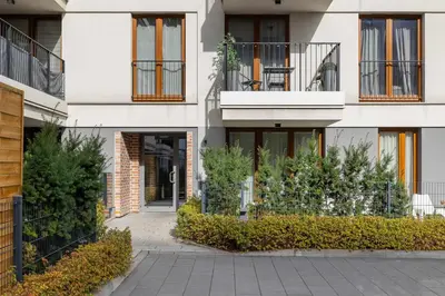 an apartment building with balconies and a courtyard at Rakowicka Brick Apartment near Station by Noclegi Renters in Kraków