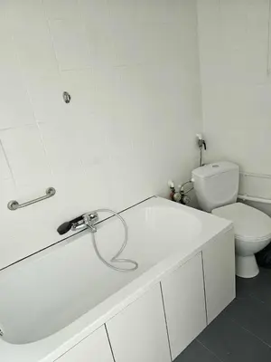 a white bathroom with a sink and a toilet at Top Apartment in Kraków