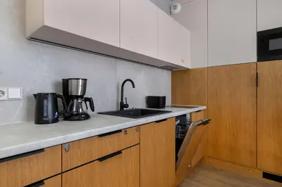 a kitchen with a sink and a counter top at Stylish Apartment with Balcony near Krakow Old Town by Noclegi Renters in Kraków