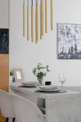 a dining room with a table with two plates and a glass at Stylish Apartment with Balcony near Krakow Old Town by Noclegi Renters in Kraków