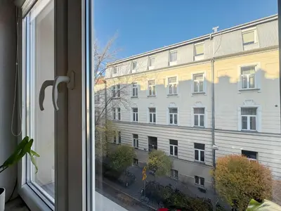 a window with a view of a building at Pstrak zyblikiewicza in Kraków