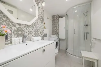 a bathroom with a shower and a toilet and a sink at Charming One Bedroom Apartment in Krakow with a Perfect Location by Noclegi Renters in Kraków
