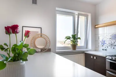 a white kitchen with a vase of flowers on a counter at ANTA Salt Mine in Wieliczka