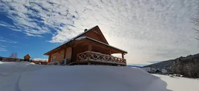 a cabin in the snow with a pile of snow at Chata Przysłop in Stryszawa