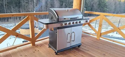 a grill on a deck on a porch at Chata Przysłop in Stryszawa