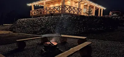 a fire pit in front of a house at night at Chata Przysłop in Stryszawa