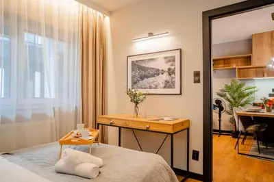 a bedroom with a desk and a bed with a table at Kraków Podgórze Apt - Parking, Balcony - by Rentujemy in Kraków