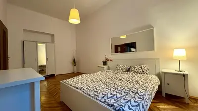 a bedroom with a large bed and a mirror at Next to Main Square 2 in Kraków