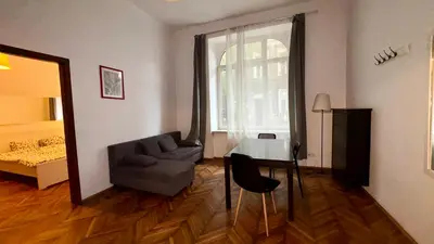 a living room with a couch and a table and a bed at Next to Main Square 2 in Kraków