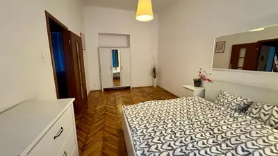 a bedroom with a bed and a mirror on the wall at Next to Main Square 2 in Kraków