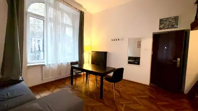 a living room with a table and a window at Next to Main Square 2 in Kraków