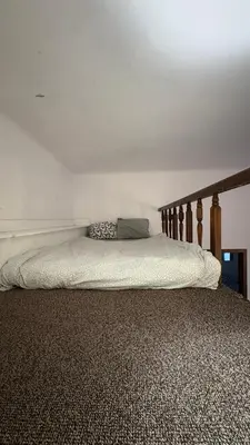 a bed in a bedroom with a wooden headboard at Next to Main Square 2 in Kraków