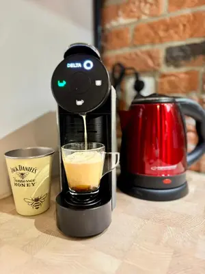 a coffee maker is making a cup of coffee at LOFT Studio Wielicka in Kraków