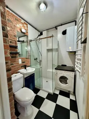 a bathroom with a toilet and a sink and a shower at LOFT Studio Wielicka in Kraków