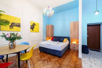 a bedroom with a bed and a table and chairs at Candy Colored House - Old Town in Kraków