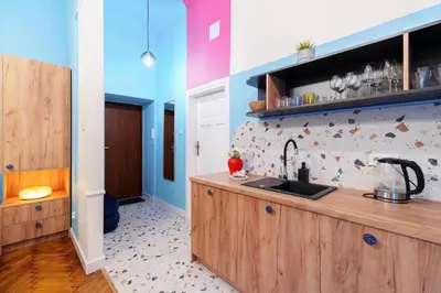 a dining room with a table and colorful chairs at Candy Colored House - Old Town in Kraków