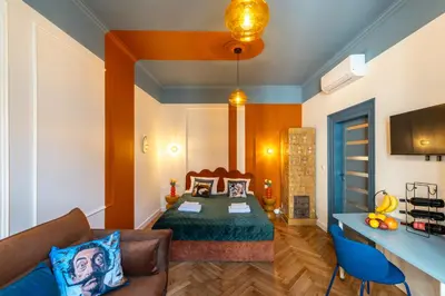 a hotel room with a bed and a blue ceiling at Candy Colored House - Old Town in Kraków