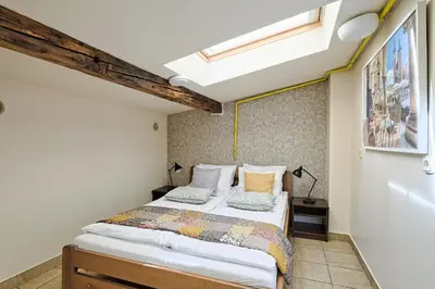 a bedroom with a bed in a room at Urban Nest - Double Room in the Attic in Kraków