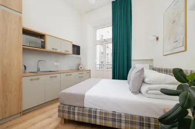a bedroom with a bed and a green curtain at Studio apartment - Augustiańska 1 street in Kraków