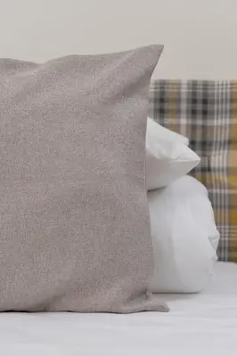 a pile of pillows sitting on top of a bed at Studio apartment - Augustiańska 1 street in Kraków