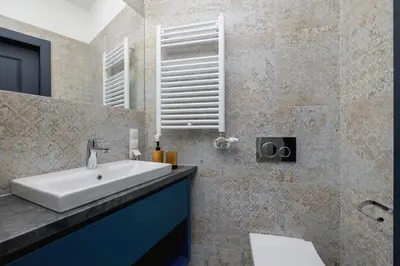 a bathroom with a sink and a mirror at Cozy studio - Augustiańska 1 street in Kraków