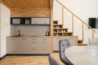 a kitchen and dining room with a table and chairs at Cozy studio - Augustiańska 1 street in Kraków