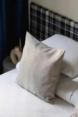 a close up of a bed with a pillow on it at Cozy studio - Augustiańska 1 street in Kraków