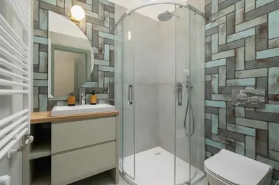 a bathroom with a shower with a toilet and a sink at Kazimierz - Augustiańska 1 street in Kraków