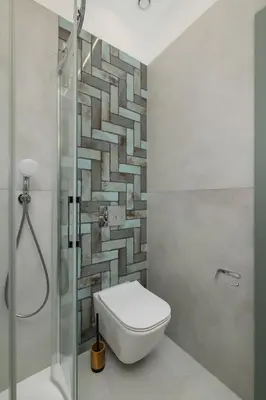 a bathroom with a toilet and a glass shower at Kazimierz - Augustiańska 1 street in Kraków