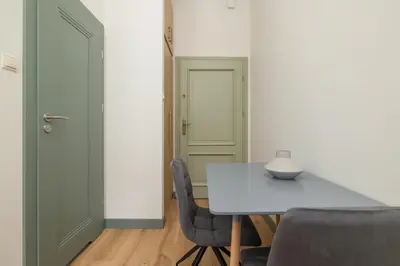 a dining room with a white table and chairs at Kazimierz - Augustiańska 1 street in Kraków