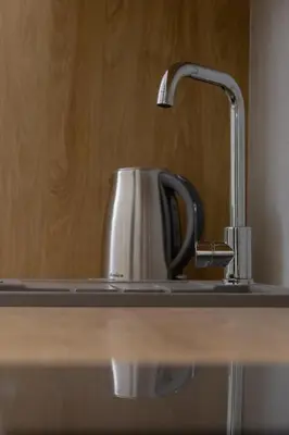 a sink with a coffee pot on a counter at Studio - Augustiańska 1 in Kraków
