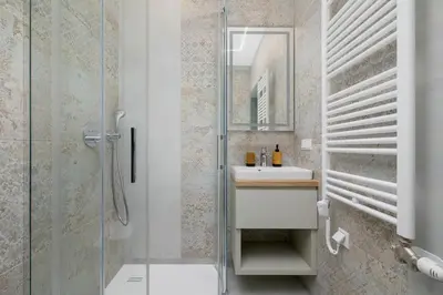 a bathroom with a sink and a shower at Studio - Augustiańska 1 in Kraków