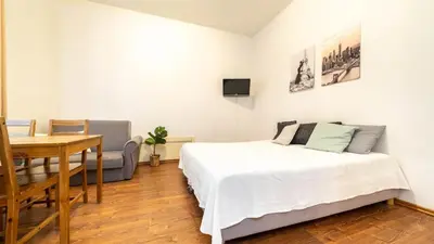 a bedroom with a bed and a table and a desk at Old Anser City in Kraków