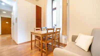 a dining room with a table and a couch at Old Anser City in Kraków