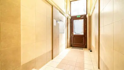 a hallway with a door and a tiled floor at Old Anser City in Kraków