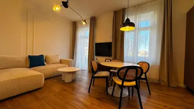 a living room with a couch and a flat screen tv at Wawel Love & Bath Apartment in Kraków