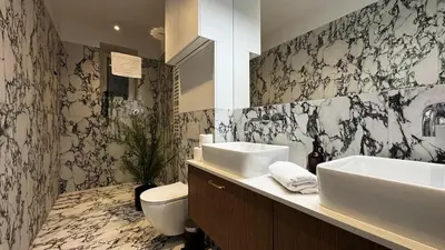 a white bath tub in a room with a bed at Wawel Love & Bath Apartment in Kraków
