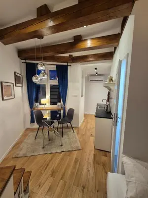 a kitchen and dining room with a table and chairs at The Hidden Echo Studio Kazimierz, #Netflix # AC# in Kraków