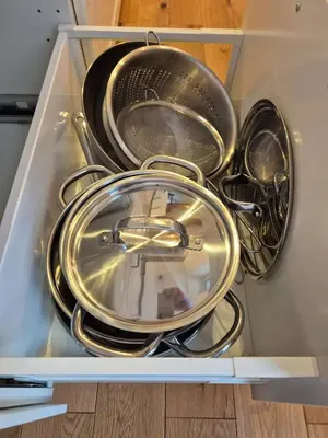 a bunch of pots and pans sitting in a refrigerator at The Hidden Echo Studio Kazimierz, #Netflix # AC# in Kraków